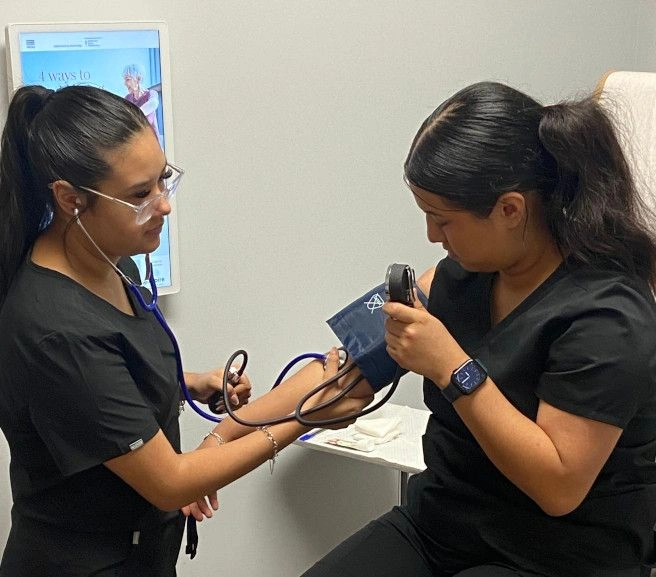 Medical students practicing taking blood pressure measurements